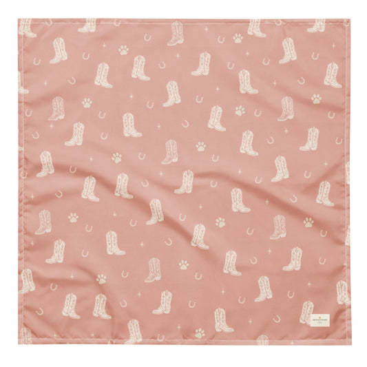 Country Pup western dog bandana featuring western cowboy boots, horseshoes, and paw prints on a blush pink background by HoneyPaw Pets.