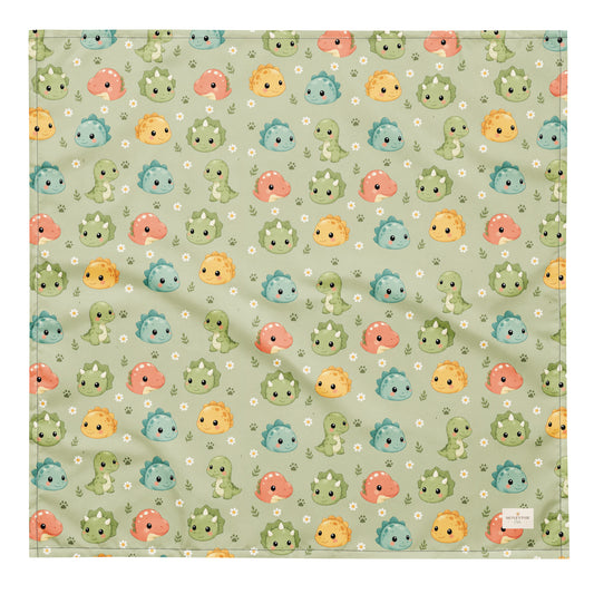 Dino Days dog bandana featuring colorful dinosaur faces and paw prints on a sage green background by HoneyPaw Pets
