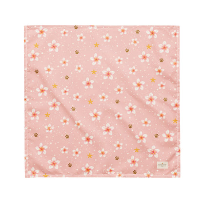 Aloha Paws dog bandana featuring pink plumeria flowers, paw prints, and golden stars on a blush pink background by HoneyPaw Pets.