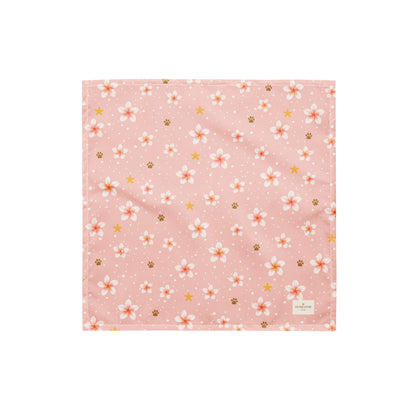 Aloha Paws dog bandana featuring pink plumeria flowers, paw prints, and golden stars on a blush pink background by HoneyPaw Pets.