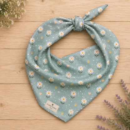 Blue Bumble dog bandana featuring white daisies, paw prints, and golden hearts on a soft blue background by HoneyPaw Pets.