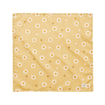 Butter Scout dog bandana featuring white daisy flowers, golden paw prints, and tiny hearts on a buttery yellow background by HoneyPaw Pets.