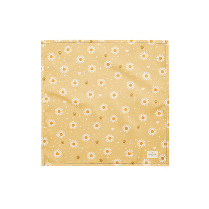 Butter Scout dog bandana featuring white daisy flowers, golden paw prints, and tiny hearts on a buttery yellow background by HoneyPaw Pets.