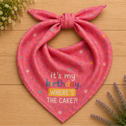 Cake Day Crew birthday dog bandana featuring colorful confetti, paw prints, and the phrase "It's My Birthday, Where's the Cake?" on a bright pink background by HoneyPaw Pets