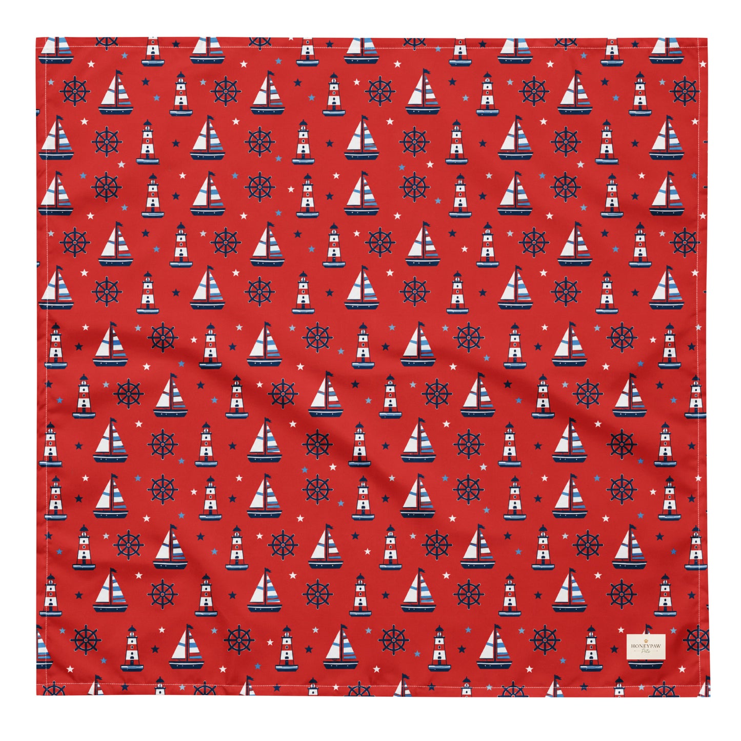 Captain's Companion dog bandana featuring a nautical sailboat and lighthouse pattern on a red background by HoneyPaw Pets.