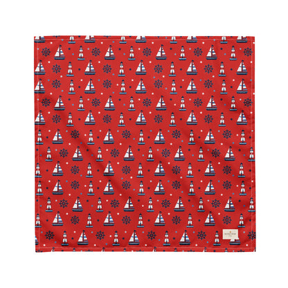 Captain's Companion dog bandana featuring a nautical sailboat and lighthouse pattern on a red background by HoneyPaw Pets.