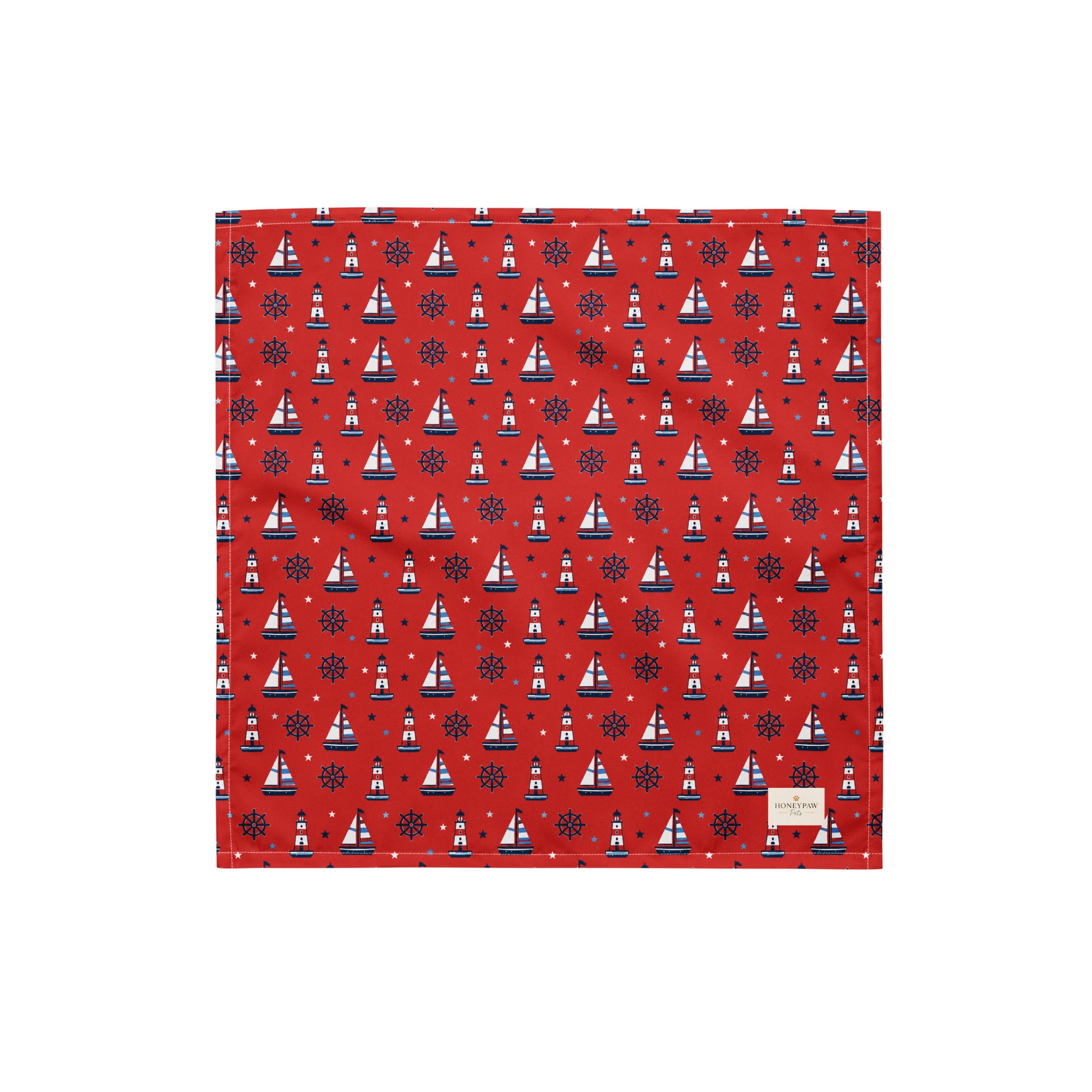 Captain's Companion dog bandana featuring a nautical sailboat and lighthouse pattern on a red background by HoneyPaw Pets.