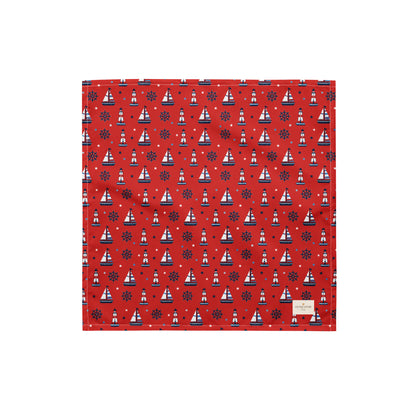 Captain's Companion dog bandana featuring a nautical sailboat and lighthouse pattern on a red background by HoneyPaw Pets.