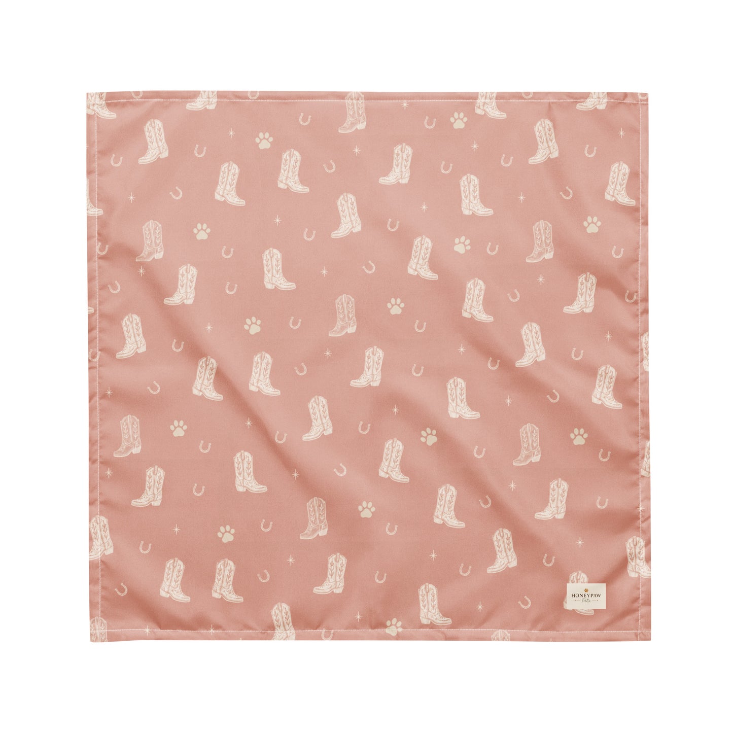 Country Pup western dog bandana featuring western cowboy boots, horseshoes, and paw prints on a blush pink background by HoneyPaw Pets.