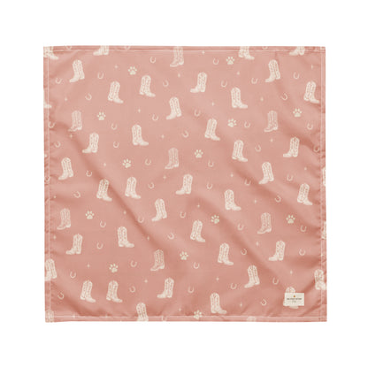 Country Pup western dog bandana featuring western cowboy boots, horseshoes, and paw prints on a blush pink background by HoneyPaw Pets.