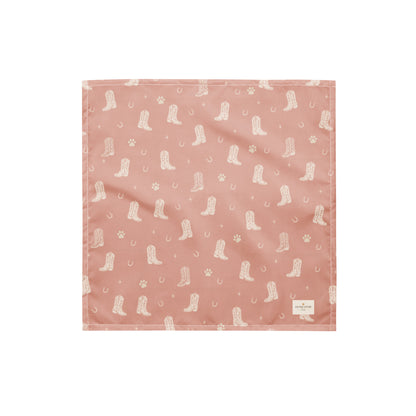 Country Pup western dog bandana featuring western cowboy boots, horseshoes, and paw prints on a blush pink background by HoneyPaw Pets.