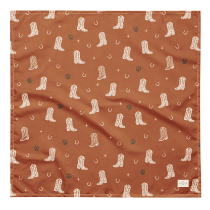 Cowboy Rover western dog bandana featuring western cowboy boots, horseshoes, and paw prints on a burnt orange background by HoneyPaw Pets.