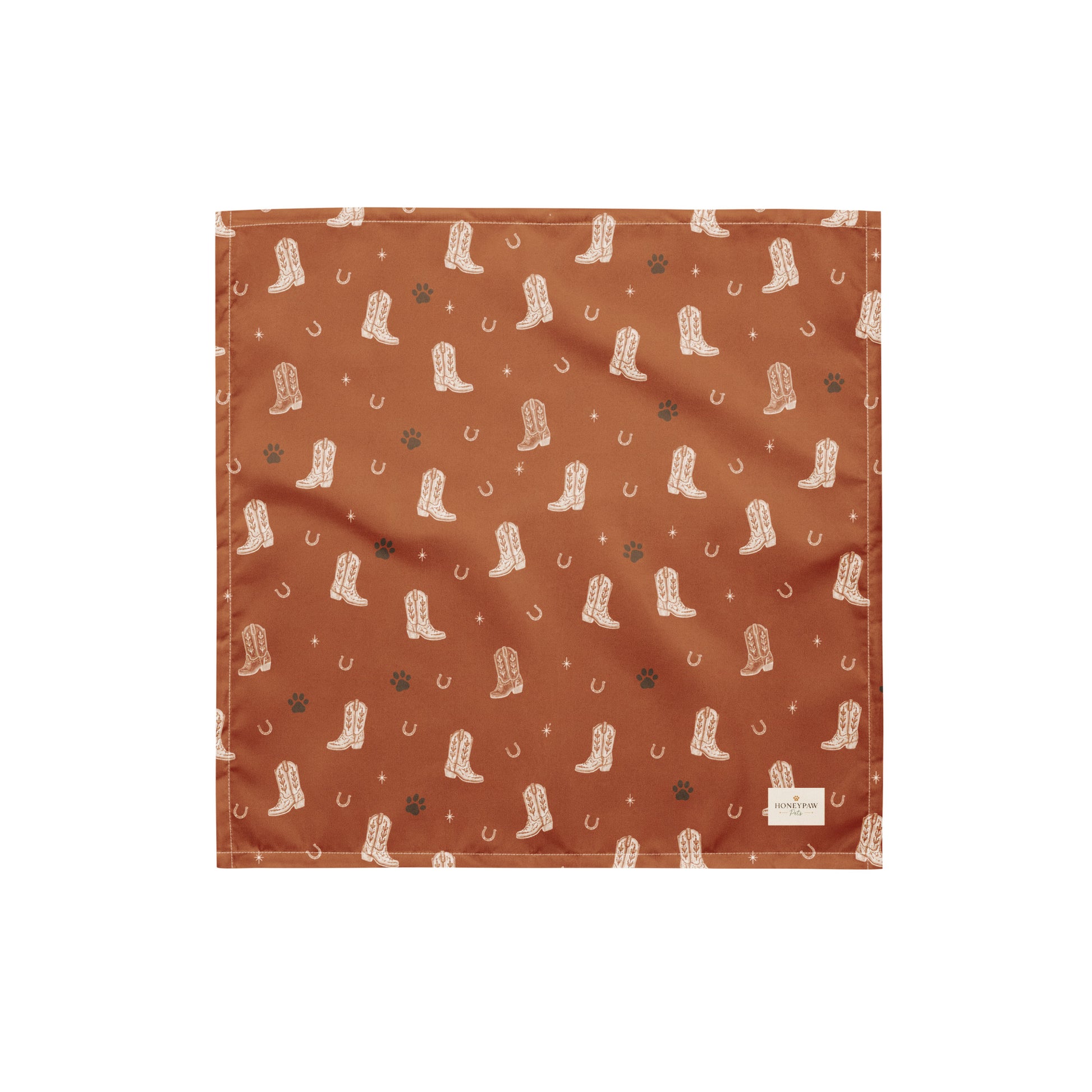 Cowboy Rover western dog bandana featuring western cowboy boots, horseshoes, and paw prints on a burnt orange background by HoneyPaw Pets.