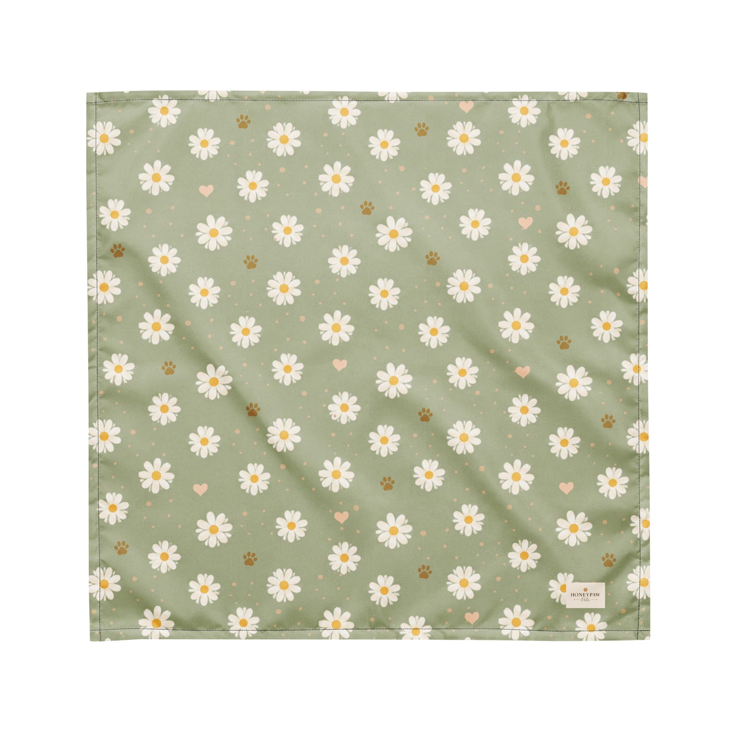 Daisy Dream dog bandana featuring white daisy flowers, golden paw prints, and tiny hearts on a soft sage green background by HoneyPaw Pets.