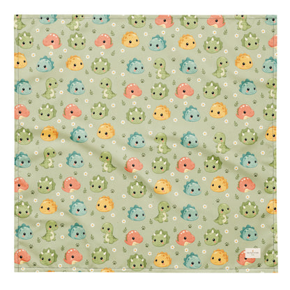 Dino Days dog bandana featuring colorful dinosaur faces and paw prints on a sage green background by HoneyPaw Pets