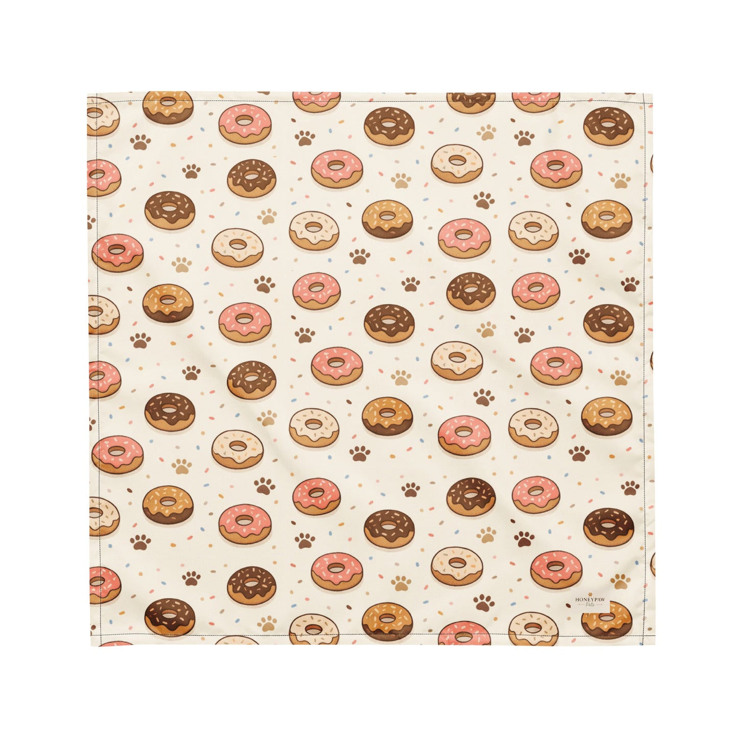 Donut Daydream dog bandana featuring pink and chocolate frosted donuts with paw prints on a cream background by HoneyPaw Pets.