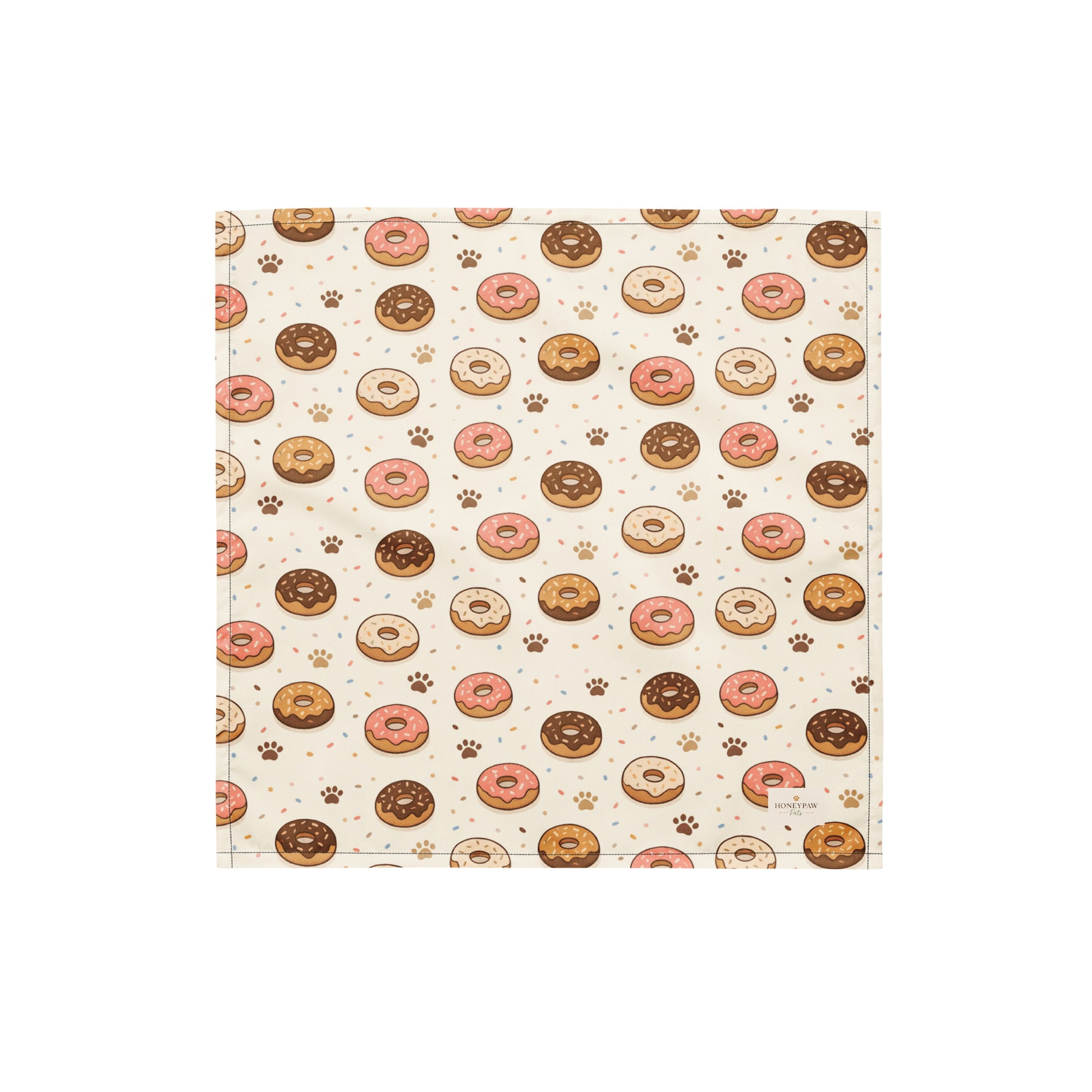 Donut Daydream dog bandana featuring pink and chocolate frosted donuts with paw prints on a cream background by HoneyPaw Pets.