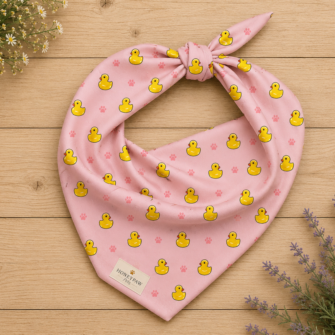 Duckie Dreams dog bandana featuring rubber ducks and paw prints on a pink background by HoneyPaw Pets