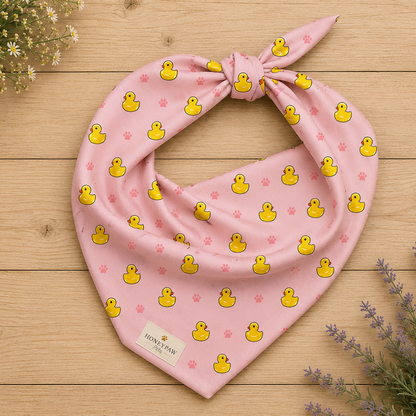 Duckie Dreams dog bandana featuring rubber ducks and paw prints on a pink background by HoneyPaw Pets