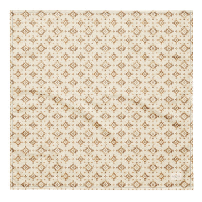 Dusty Paws dog bandana featuring a cream background with a western-inspired geometric pattern in warm tan tones by HoneyPaw Pets.