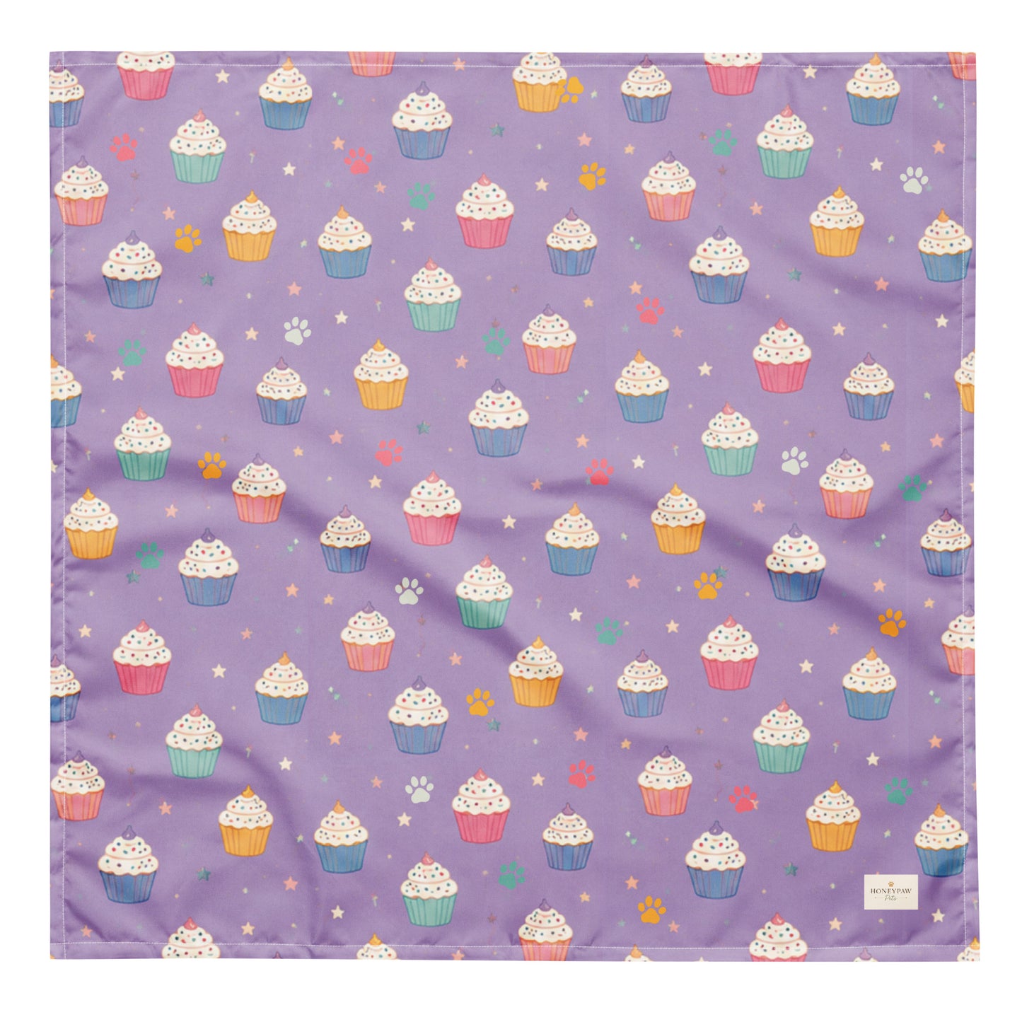 Frosted Paws dog bandana featuring colorful cupcakes, paw prints, and stars on a lavender purple background by HoneyPaw Pets