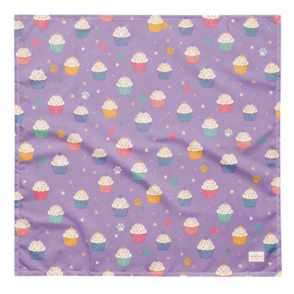 Frosted Paws dog bandana featuring colorful cupcakes, paw prints, and stars on a lavender purple background by HoneyPaw Pets