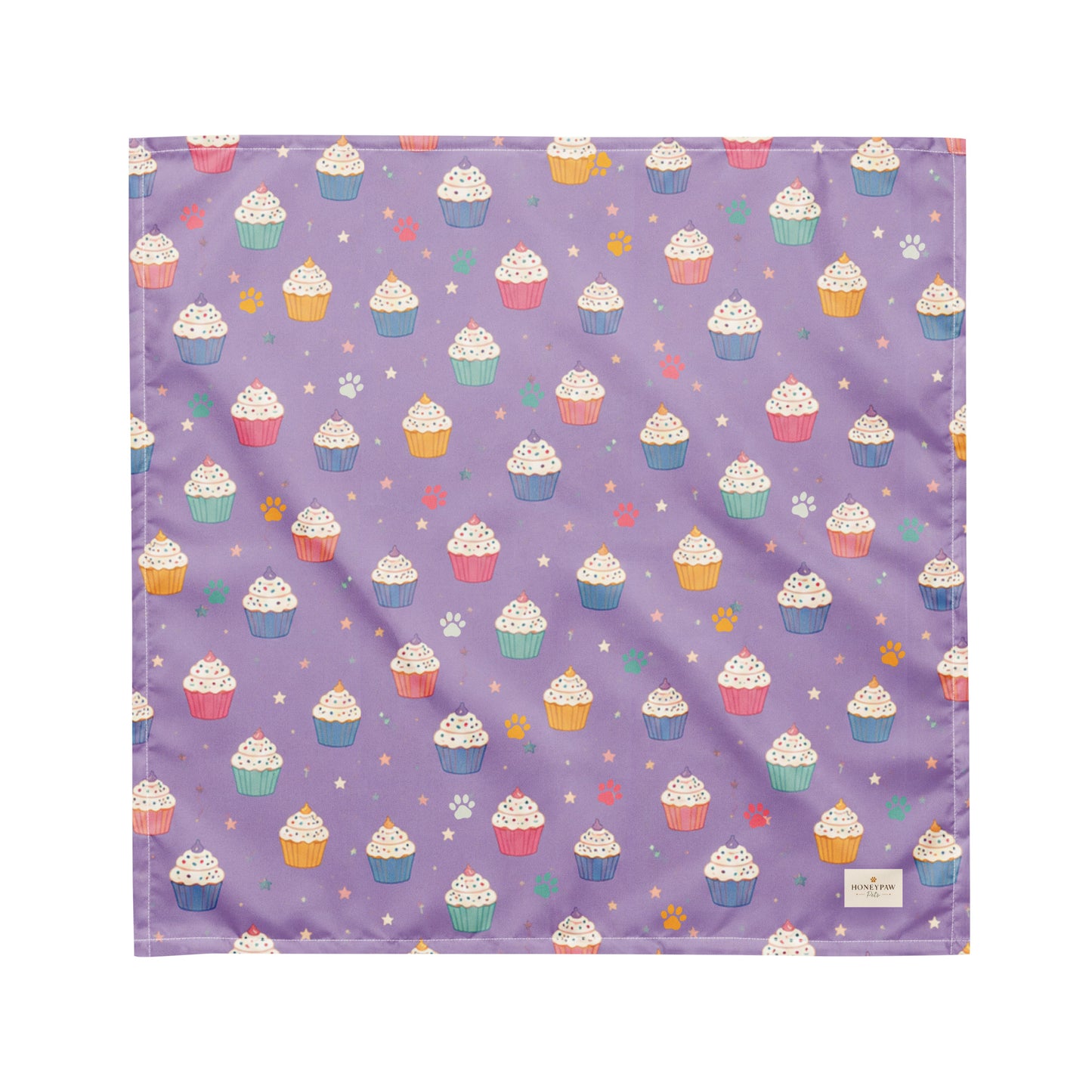 Frosted Paws dog bandana featuring colorful cupcakes, paw prints, and stars on a lavender purple background by HoneyPaw Pets