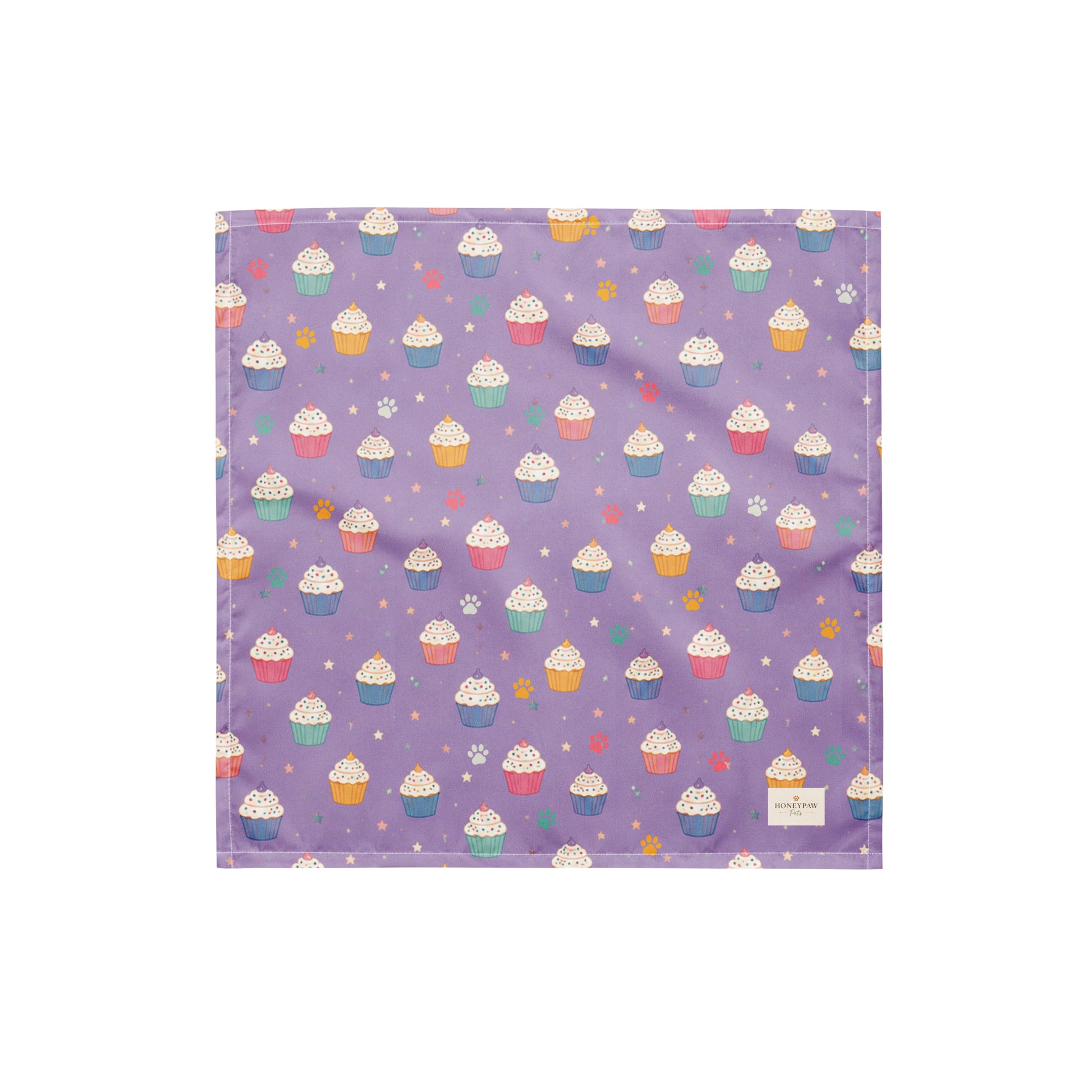 Frosted Paws dog bandana featuring colorful cupcakes, paw prints, and stars on a lavender purple background by HoneyPaw Pets