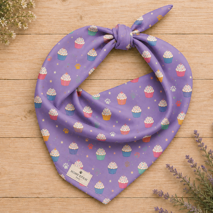 Frosted Paws dog bandana featuring colorful cupcakes, paw prints, and stars on a lavender purple background by HoneyPaw Pets