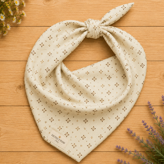 Display photo of a cream patterned HoneyPaw Pets dog bandana on a wood background