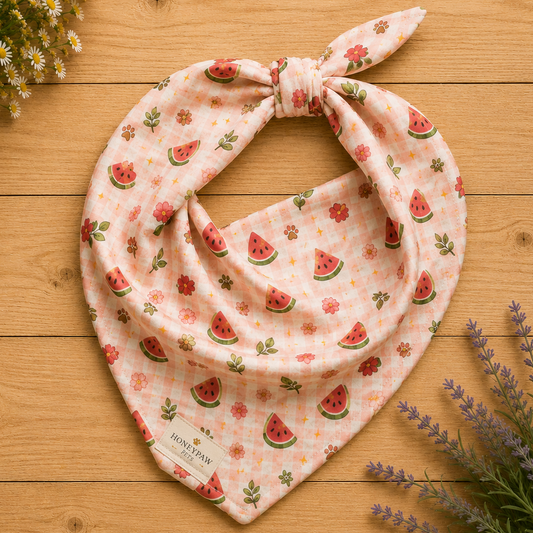 Display photo of a pink plaid and watermelon HoneyPaw Pets dog bandana on a wood background