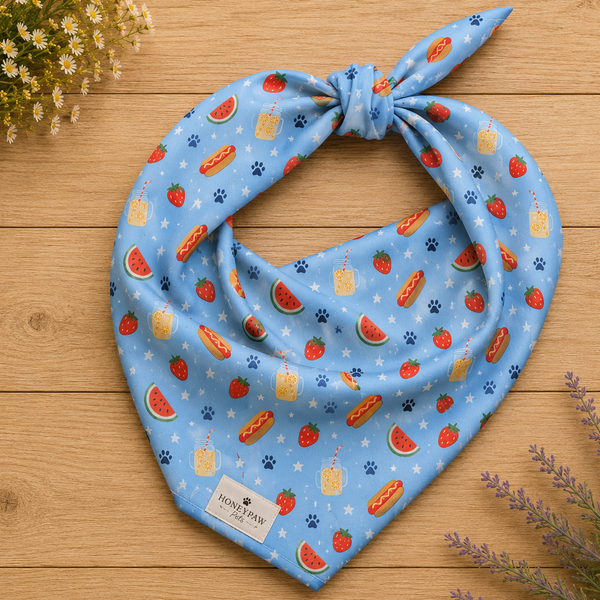 Hot Dog dog bandana featuring a summer picnic pattern with hot dogs, watermelon, and strawberries on a light blue background by HoneyPaw Pets.