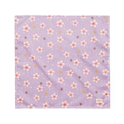 Island Scent dog bandana featuring pink plumeria flowers, paw prints, and golden stars on a lavender background by HoneyPaw Pets.