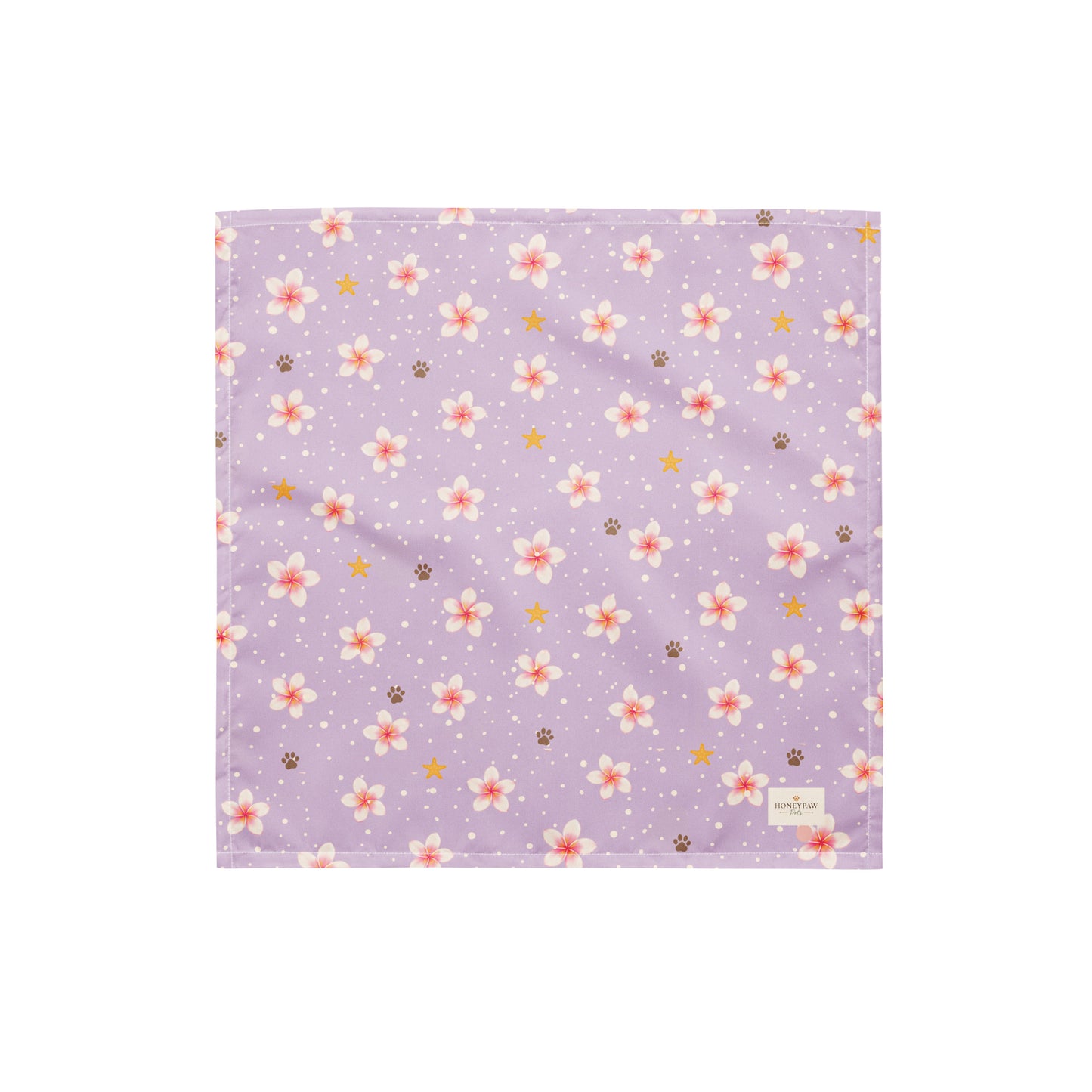 Island Scent dog bandana featuring pink plumeria flowers, paw prints, and golden stars on a lavender background by HoneyPaw Pets.