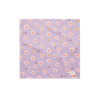 Island Scent dog bandana featuring pink plumeria flowers, paw prints, and golden stars on a lavender background by HoneyPaw Pets.
