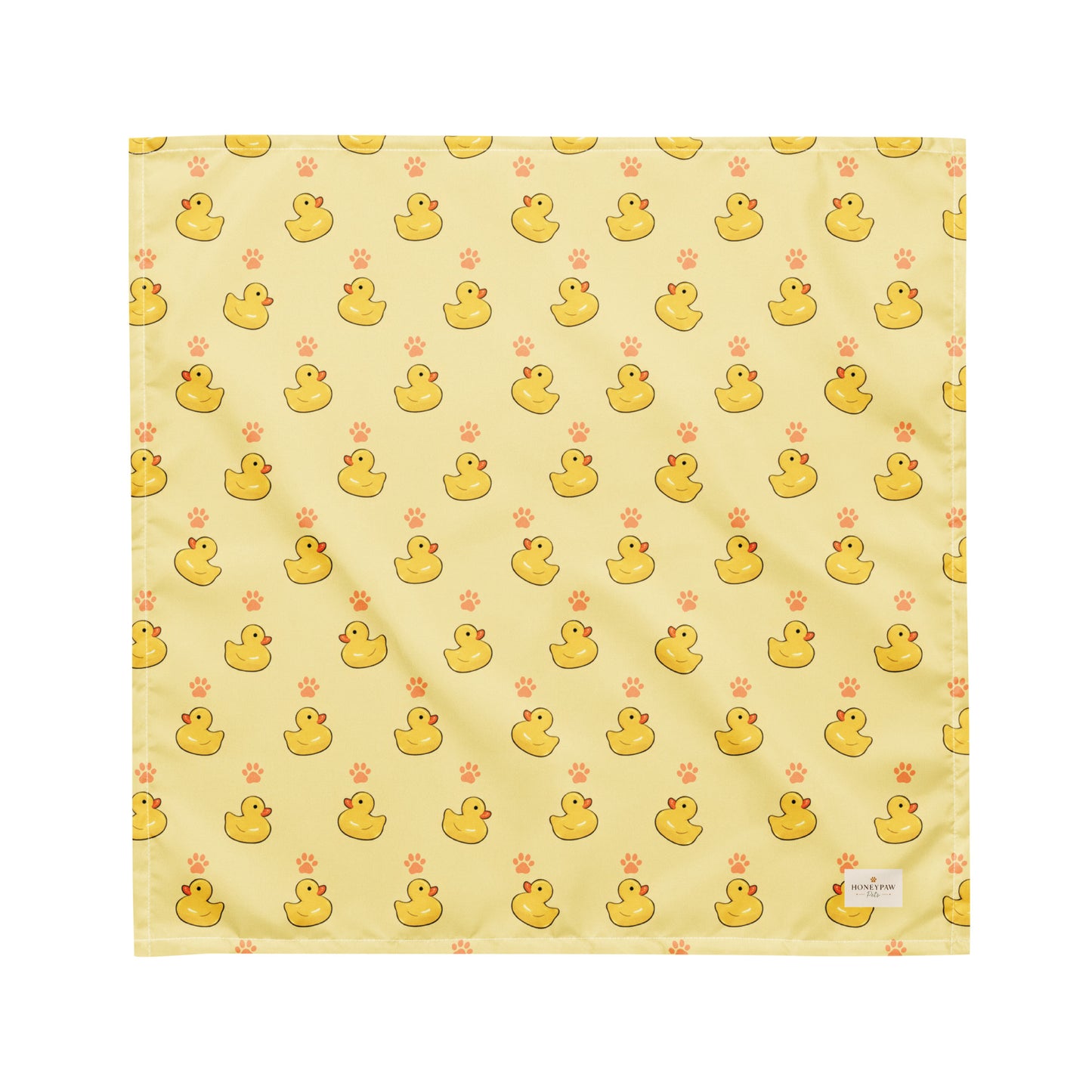 Lucky Duck dog bandana featuring rubber ducks and paw prints on a yellow background by HoneyPaw Pets