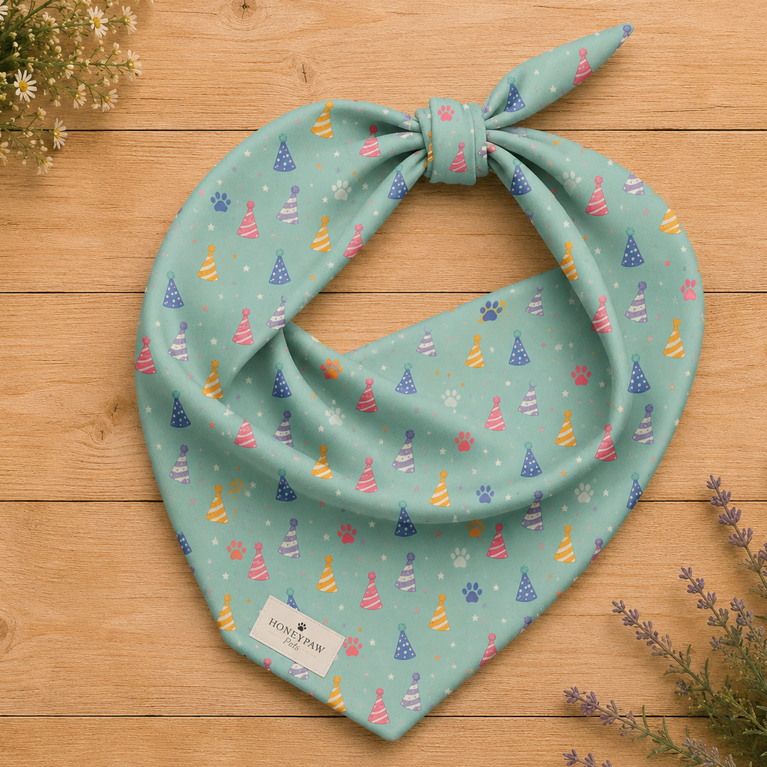 Party Animal birthday dog bandana featuring colorful party hats and paw prints on a mint green background by HoneyPaw Pets