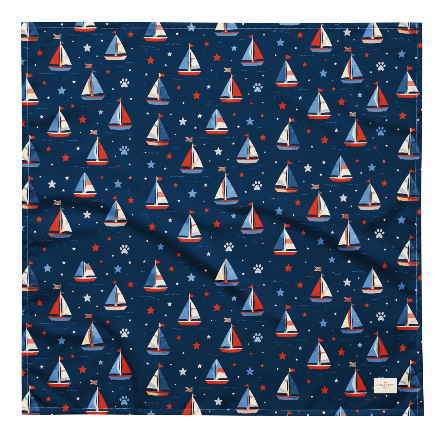 Paws at Sea dog bandana featuring a nautical sailboat pattern on a navy blue background by HoneyPaw Pets.
