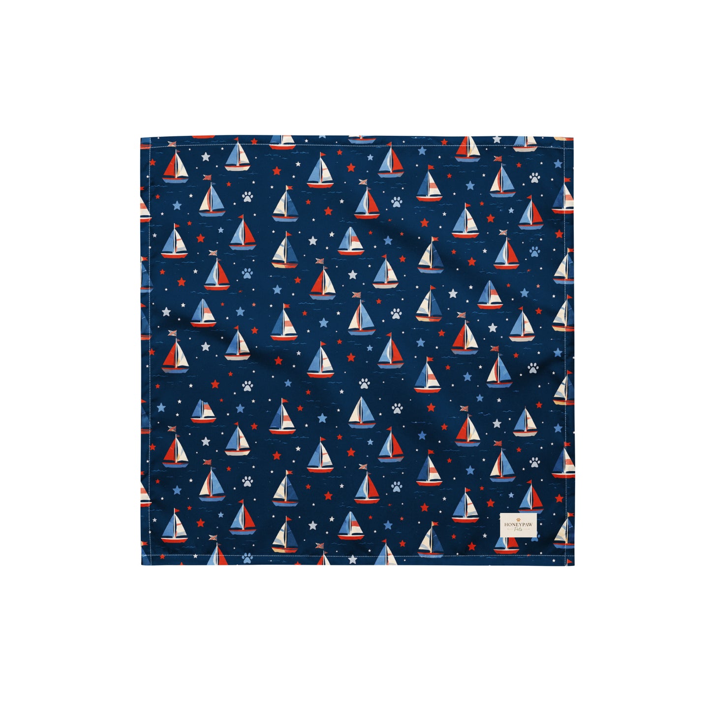 Paws at Sea dog bandana featuring a nautical sailboat pattern on a navy blue background by HoneyPaw Pets.