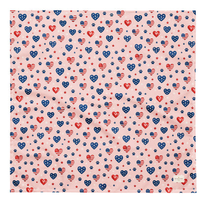 Picnic Hearts dog bandana featuring patriotic heart and paw print patterns on a blush pink background by HoneyPaw Pets.