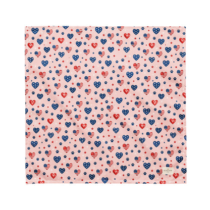 Picnic Hearts dog bandana featuring patriotic heart and paw print patterns on a blush pink background by HoneyPaw Pets.