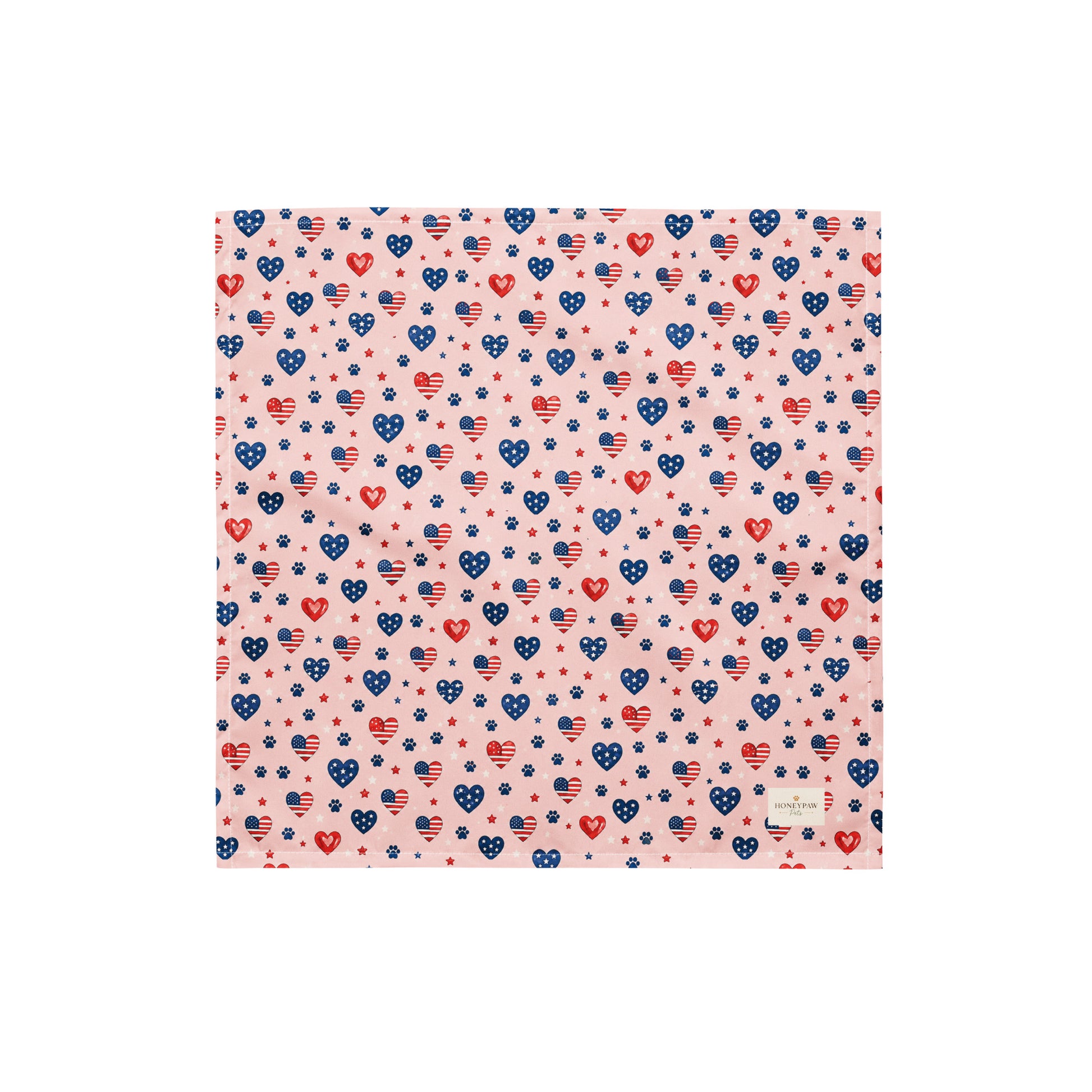 Picnic Hearts dog bandana featuring patriotic heart and paw print patterns on a blush pink background by HoneyPaw Pets.