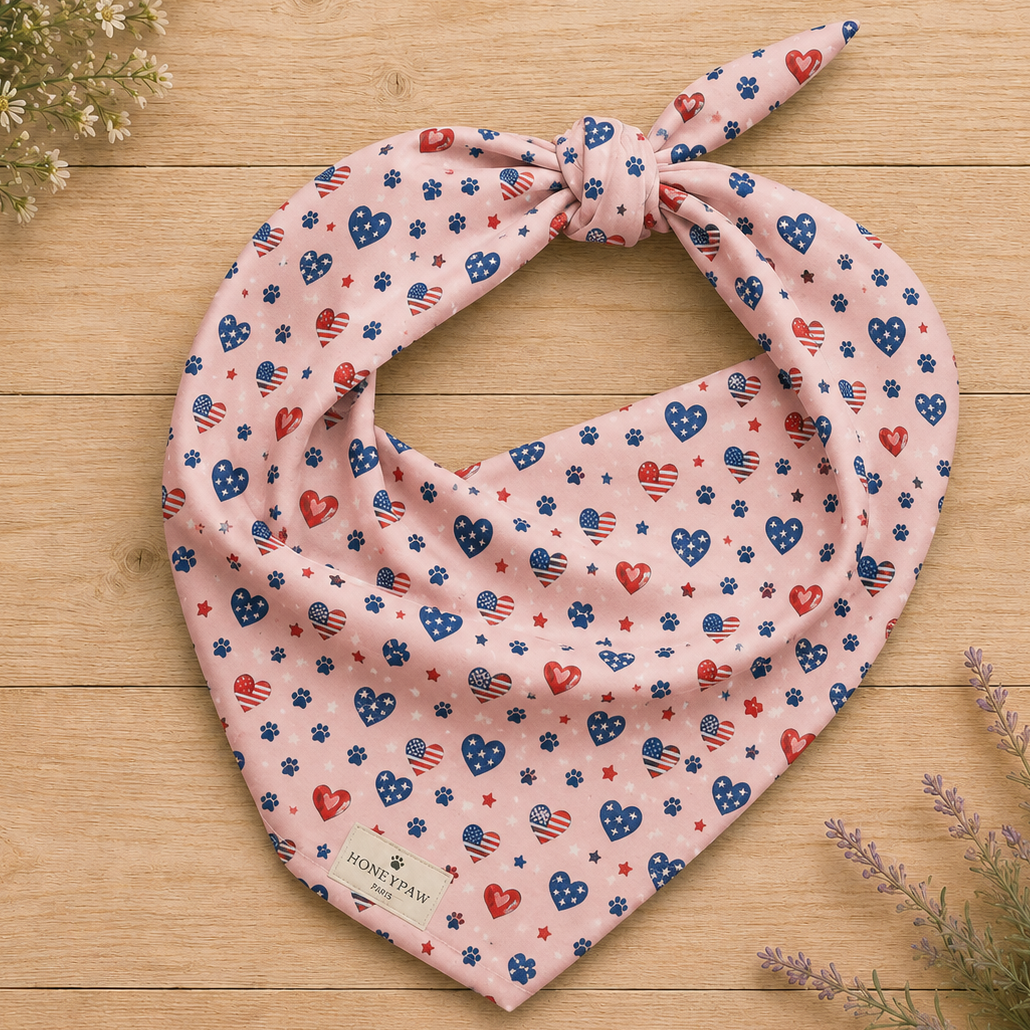 Picnic Hearts dog bandana featuring patriotic heart and paw print patterns on a blush pink background by HoneyPaw Pets.