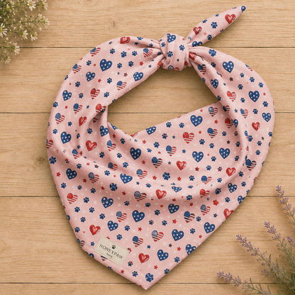 Picnic Hearts dog bandana featuring patriotic heart and paw print patterns on a blush pink background by HoneyPaw Pets.
