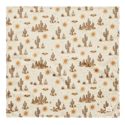 Prickly Pup dog bandana featuring a cream background with hand-drawn desert cacti, sunshine motifs, and southwestern-inspired details in warm earth tones by HoneyPaw Pets.