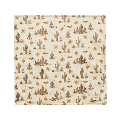Prickly Pup dog bandana featuring a cream background with hand-drawn desert cacti, sunshine motifs, and southwestern-inspired details in warm earth tones by HoneyPaw Pets.