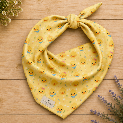 Quack Pack dog bandana featuring duck faces and paw prints on a yellow background by HoneyPaw Pets