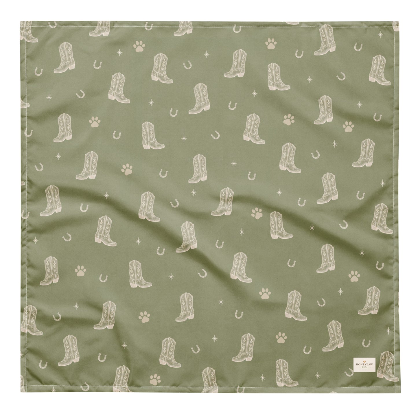 Rodeo Print western dog bandana featuring western cowboy boots, horseshoes, and paw prints on a sage green background by HoneyPaw Pets.