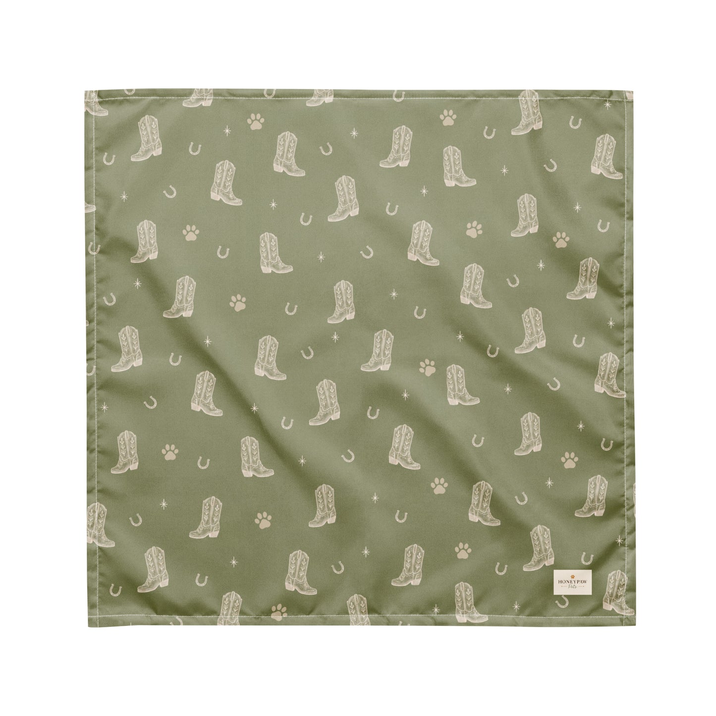 Rodeo Print western dog bandana featuring western cowboy boots, horseshoes, and paw prints on a sage green background by HoneyPaw Pets.