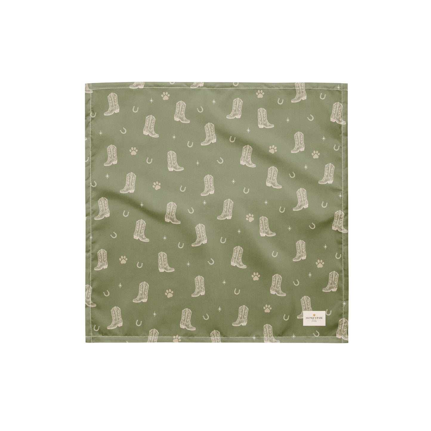 Rodeo Print western dog bandana featuring western cowboy boots, horseshoes, and paw prints on a sage green background by HoneyPaw Pets.